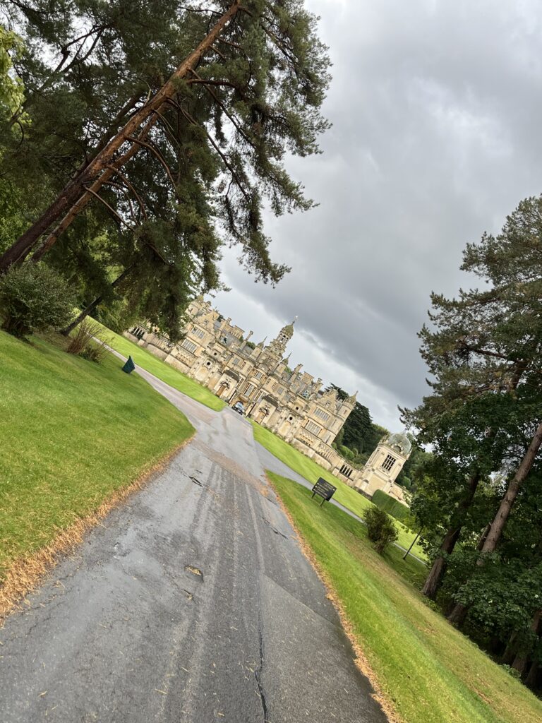 A view of Harlaxton Manor from afar, approaching the building from the long driveway.